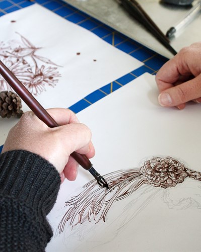 Hand drawing a detailed pinecone in pen