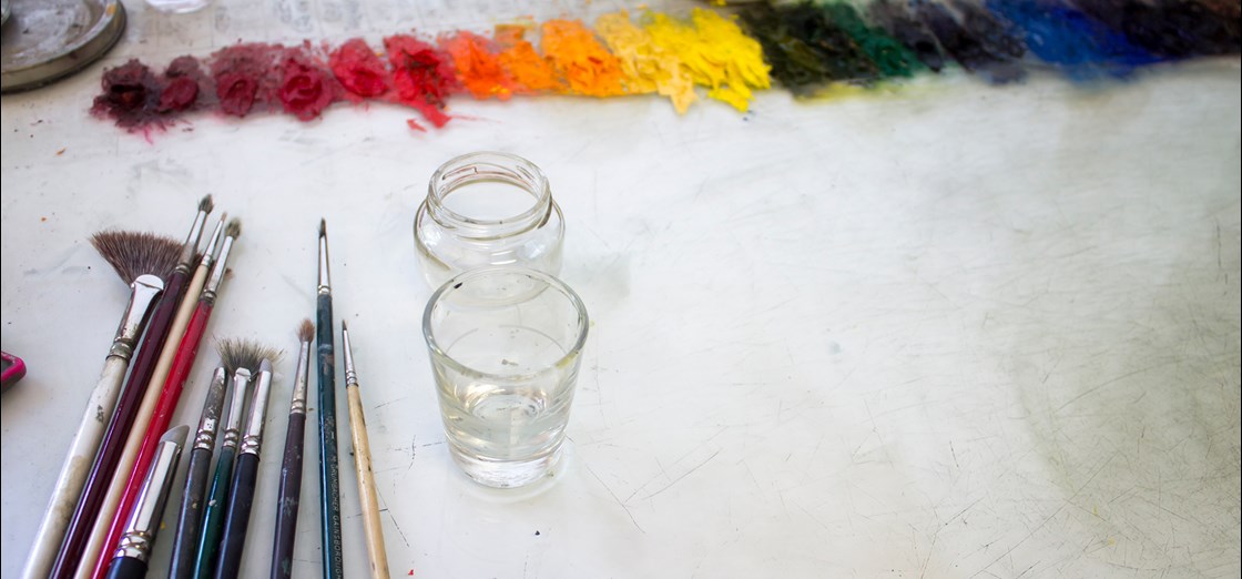 Photograph of paintbrushes and colored pigments