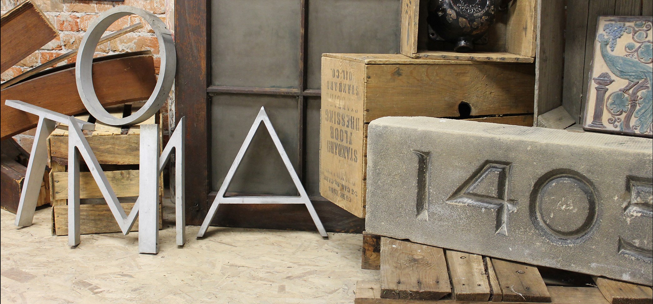 Header image of crates, bricks, and large metal letters