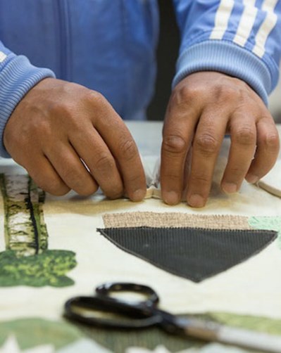 Person working on quilted artwork