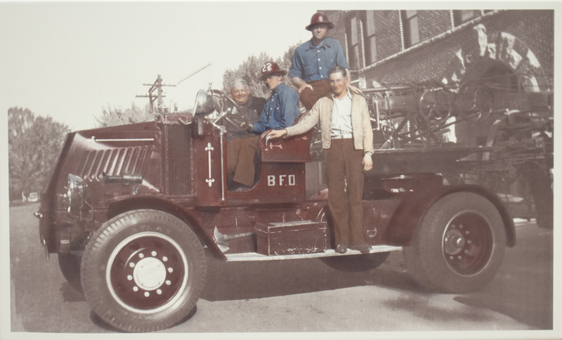An image of several men standing in a Mack Bulldog tractor from 1923. 