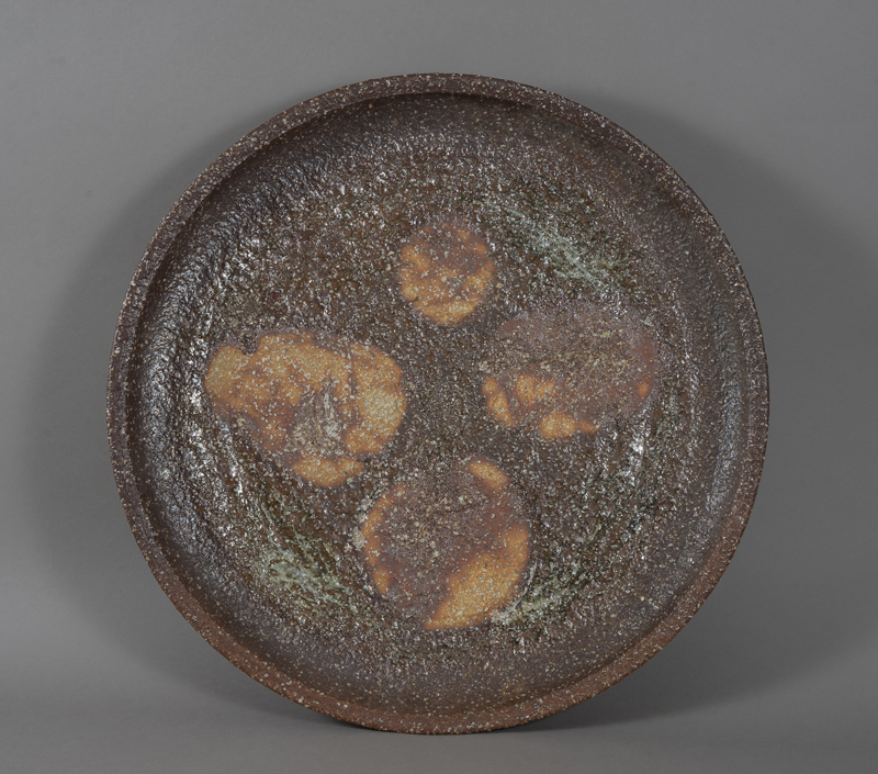 A large ceramic platter with a brown "sugary" textured glaze.
