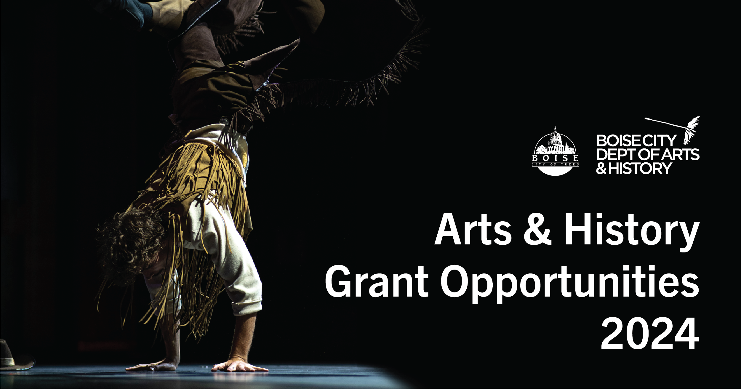 A male dancer wearing a western outfit is standing on his hands. His cowboy hat is laying on the stage in front of him. The City of Boise and the Boise City Dept. of Arts & History logos, along with Arts & History Grant Opportunities 2024 are written in white type on a black background.