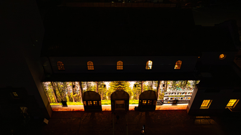 An ariel photograph of the Boise Depot at sunset. On the front of the building is a bright animated projection.