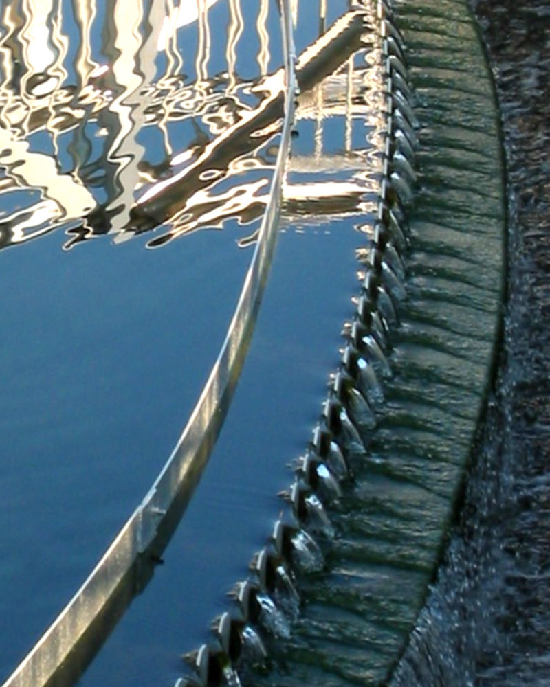Water gently cascading down several tiers of a separator meant to remove unwanted materials. 