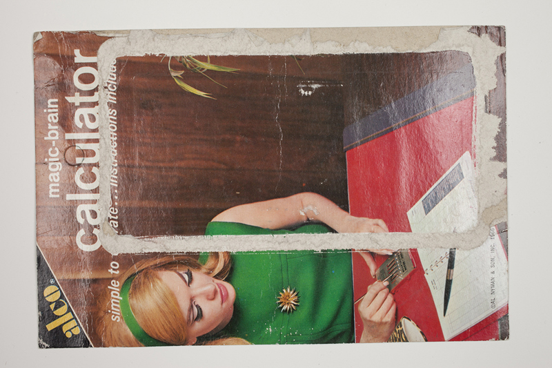 The printed backing of a "Magic-Brain Calculator" packaging board.